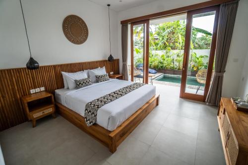 Postel nebo postele na pokoji v ubytování Kemari Ubud