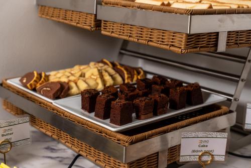 a tray of brownies and other pastries on a shelf at 22Land Cloud Hotel in Hanoi