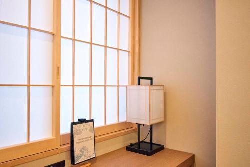 a room with a window with a sign in front of it at MKG HOTEL Asakusa in Tokyo