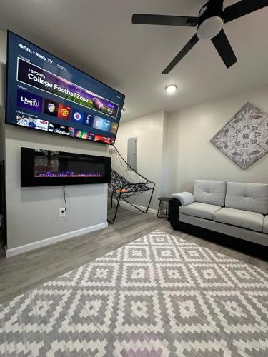 a living room with a flat screen tv and a couch at Luxury Modern Gatlinburg Cabin Hot Tub and Sauna in Gatlinburg