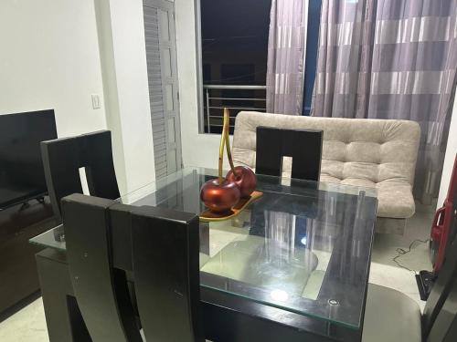 a glass table in a living room with a fruit on it at Apartamento en Nuevo Apartado 1 in Apartadó