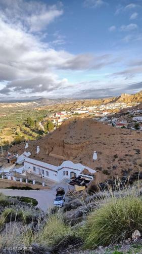 a white building on top of a hill at Bike Cueva Gorafe in Gorafe