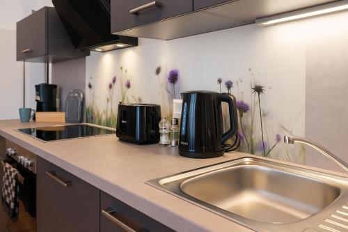 a kitchen with a sink and a counter top at Savor City Appartement Am Lauenturm Zentrum 5 Personen in Bautzen