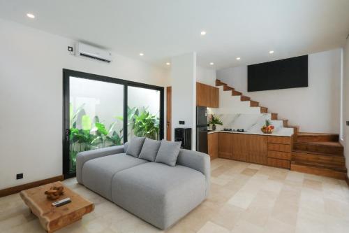 a living room with a couch and a table at Tierra Villas Pererenan, Canggu by Blacksand in Canggu