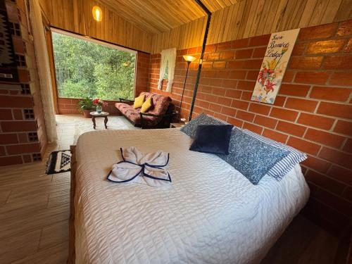 a bedroom with a bed with a bow on it at Green Bamboo Lodge in San Francisco de Borja