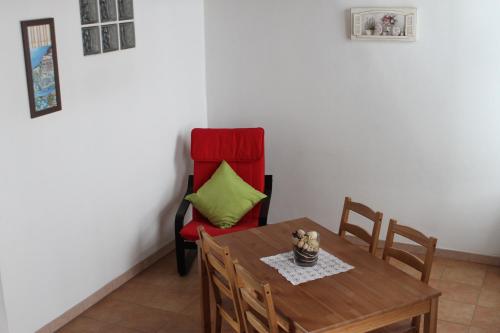 a dining room with a table and a chair at Le Camere Di Aladino in Carugate