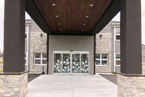 a front door of a building with a wooden ceiling at Sleep Inn & Suites Quebec City East in Boischâtel