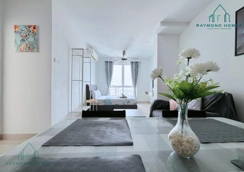 a living room with a vase with flowers on a table at Gurney Drive Mansion One Serviced Apartment in George Town