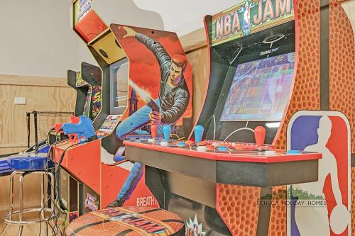 a game room with a table and a video game at The Rad Shack in Echuca
