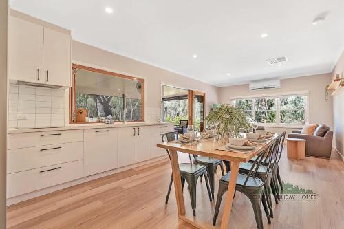 a kitchen and dining room with a table and chairs at The Rad Shack in Echuca