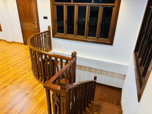 a wooden staircase in a room with a window at Mamma swiss restaurant in Jaffna
