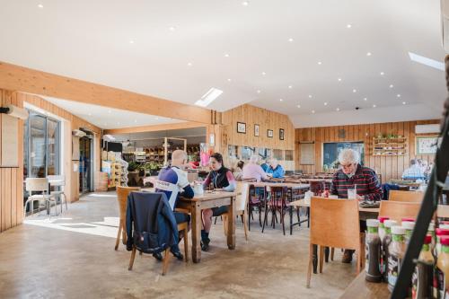 a group of people sitting at tables in a restaurant at Gatekeepers Cottage - Idyllic 4 Bed Rural Escape! in Cropthorne
