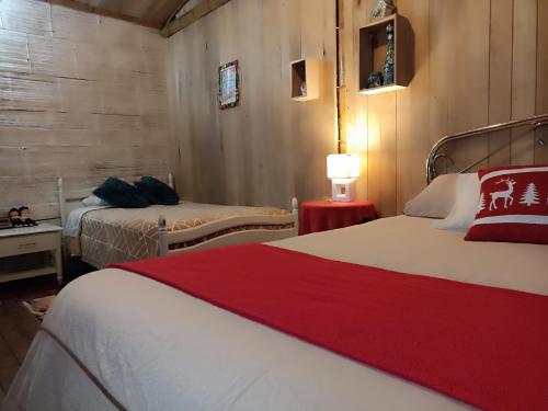 a hotel room with two beds and a lamp at Green Bamboo Lodge in San Francisco de Borja