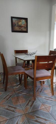 a dining room with a table and chairs at Suit Confort in Porto Velho