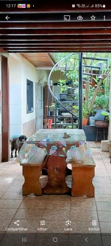a bed in a room with a dog in the background at Suit Confort in Porto Velho