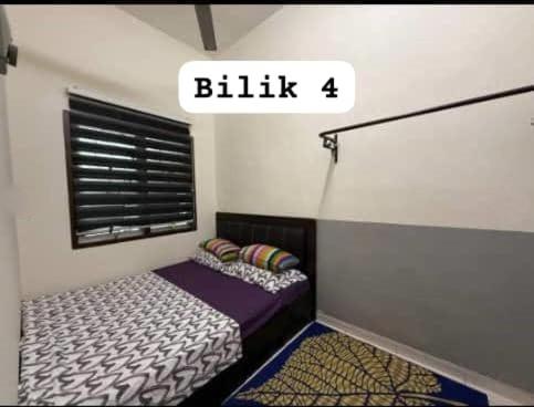 a small bedroom with a bed and a window at HOMESTAY TERATAKMUSLIM KHAIRUL&ROZAINI Melaka in Melaka