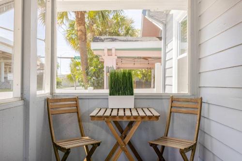 two chairs and a table with a laptop on a porch at Downtown Hideaway 1-Bedroom Bungalow in St. Petersburg
