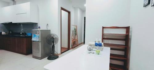 a kitchen with a refrigerator and a counter with a fan at Bcons Garden Luxury Aparment in Dĩ An