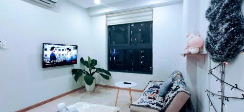 a living room with a couch and a window at Bcons Garden Luxury Aparment in Dĩ An
