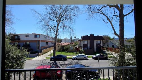 a view from a balcony of a street with parked cars at GilmoreOne in Van Nuys