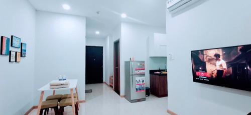 a living room with a tv on a wall at Bcons Garden Luxury Aparment in Dĩ An