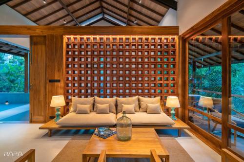 a living room with a couch and a table at Paradise Itzu in Kandy
