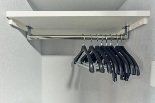 a bunch of utensils are hanging on a rack at Vacation Rental Hotel TENMONKAN in Kagoshima