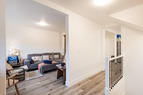 a living room with a couch and a table at Beautiful Vancouver Cedar Cottage House in Vancouver