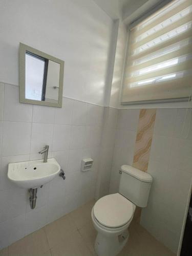 a bathroom with a toilet and a sink at Dannykaela Transient House in Vigan