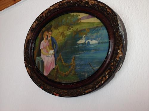 a framed painting of two women on a wall at Dino's Cottage in Sarti