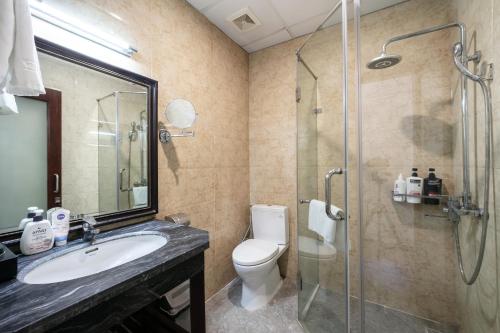 a bathroom with a toilet and a sink and a shower at A25 Hotel - 63A Phương Liệt in Hanoi