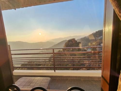 a balcony with a view of a mountain view at Leela In The Flavours of Nature in Dagshai