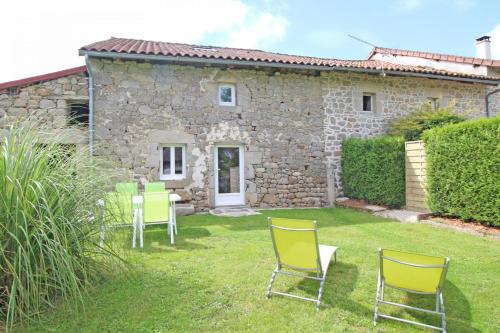 a garden with chairs and a stone house at Lo maisou in Pensol