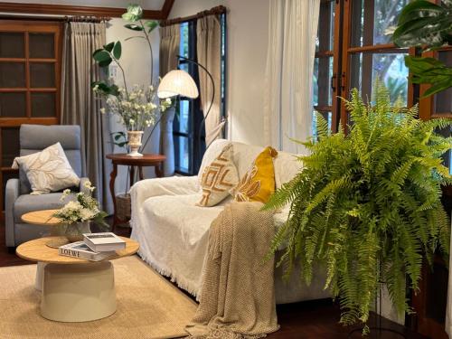 a living room with a bed and a table at Full House Chiang Mai in Chiang Mai