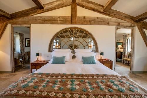 a large bedroom with a large bed in a room at La Bastide in Oppède