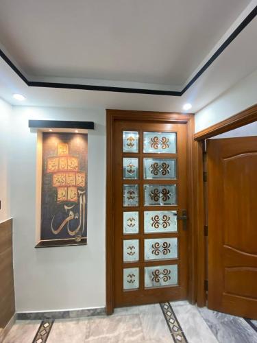 a room with a door and a painting on the wall at Gulistan Inn in Faisalabad