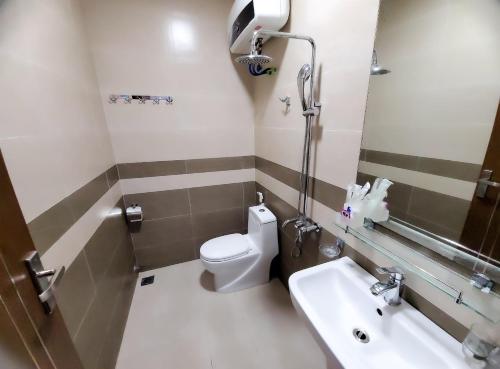 a bathroom with a toilet and a sink at Cat Ba Charm Island Hotel in Cat Ba