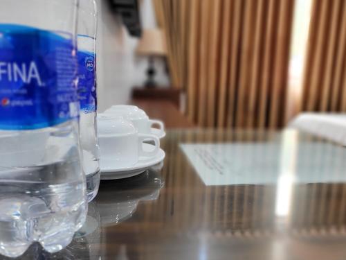 a bottle of water sitting on top of a table at Cat Ba Charm Island Hotel in Cat Ba
