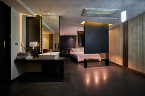 a hotel room with a bed and a sink at Yeoksam Lumiere Hotel in Seoul