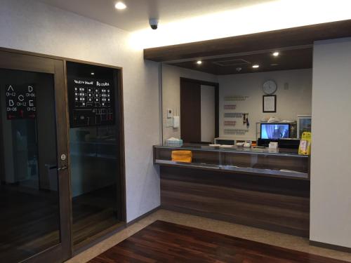 a restaurant with a cash register and a counter at BEPPU ROJIURA stay&sauna in Beppu