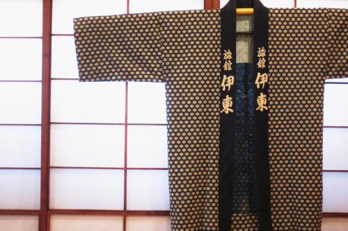 a letter t on the side of a wall at Ito Ryokan in Tokyo