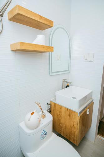 a bathroom with a white toilet and a sink at Love, Lourdes Villa in Imus
