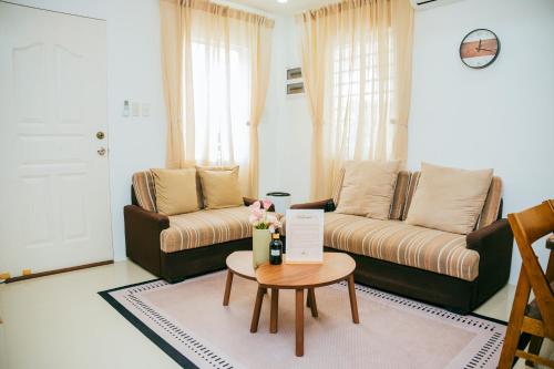 a living room with a couch and a table at Love, Lourdes Villa in Imus