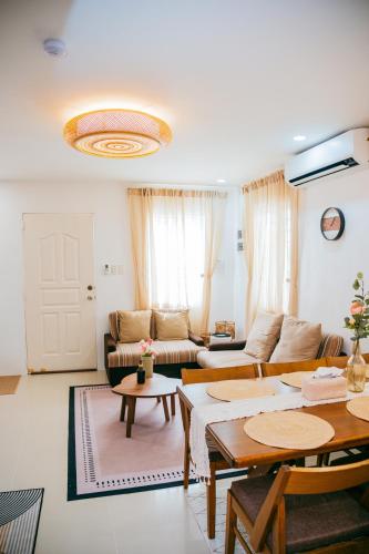 a living room with a couch and a table at Love, Lourdes Villa in Imus
