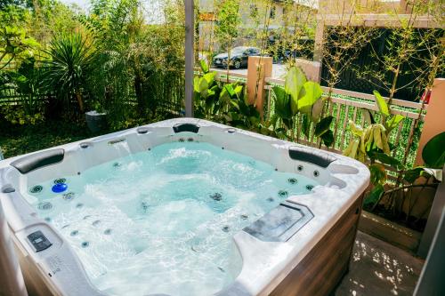a jacuzzi tub in a backyard with plants at Love, Lourdes Villa in Imus