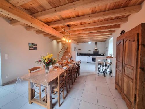 une grande salle à manger avec une table et des chaises en bois dans l'établissement Maison de Campagne Confortable pour 10 Personnes avec Wifi - FR-1-496-347, à Gumières