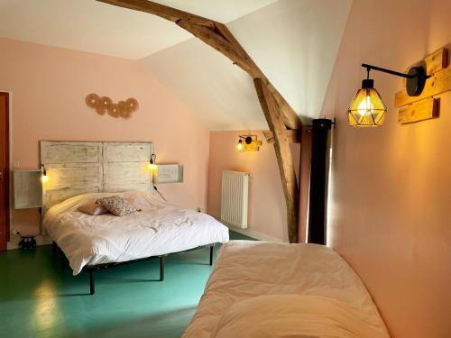 a bedroom with a bed with a headboard and a tree at Gîte tout confort 2 ch, jardin, proche Blois & Chambord - FR-1-491-463 in Saint-Claude-de-Diray