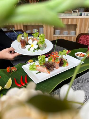 two plates of food sitting on top of a table at Vinholidays Fiesta Phu Quoc in Phu Quoc