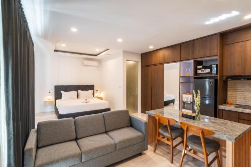 a living room with a couch and a bed at Alyxia 1 Bedroom Apartment in Central Seminyak in Seminyak