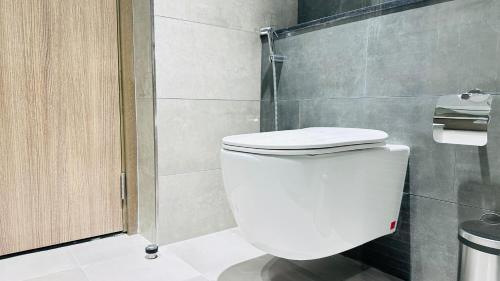 a bathroom with a white toilet and a shower at Sunday Sheikh Zayed Road Concord Tower by Belvilla in Dubai